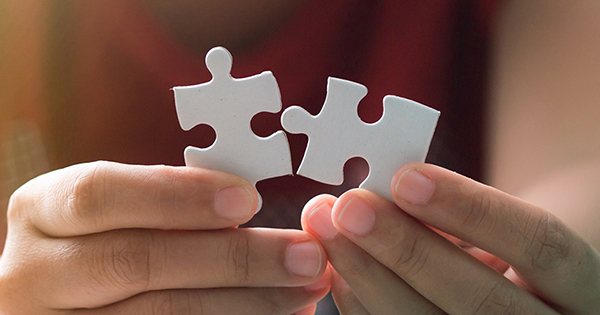 Close up shot hands of woman holding paper jigsaw puzzle Close up shot hands of woman holding paper jigsaw puzzle image
