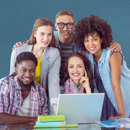 Portrait of happy classmates using laptop on table