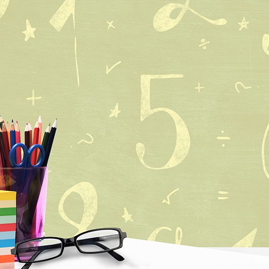 Spectacles and pen holder against mathematical image