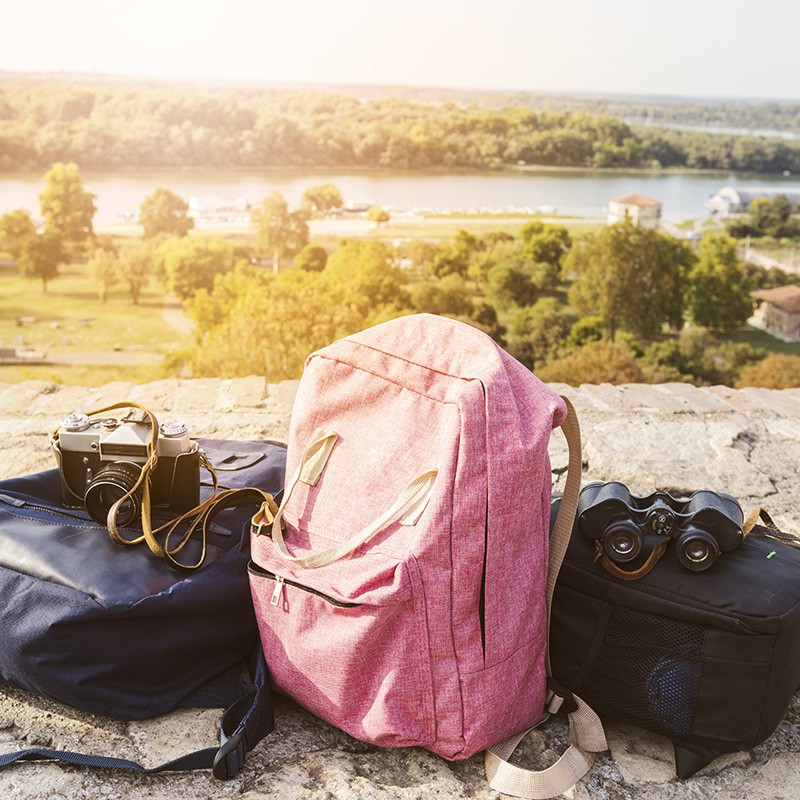 Backpack binoculars and camera outdoors