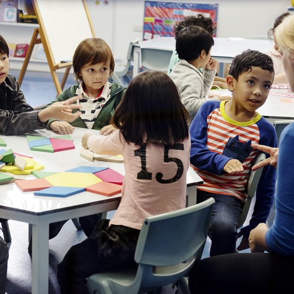 Happy kids at primary school with teacher Happy kids at primary school with teacher
