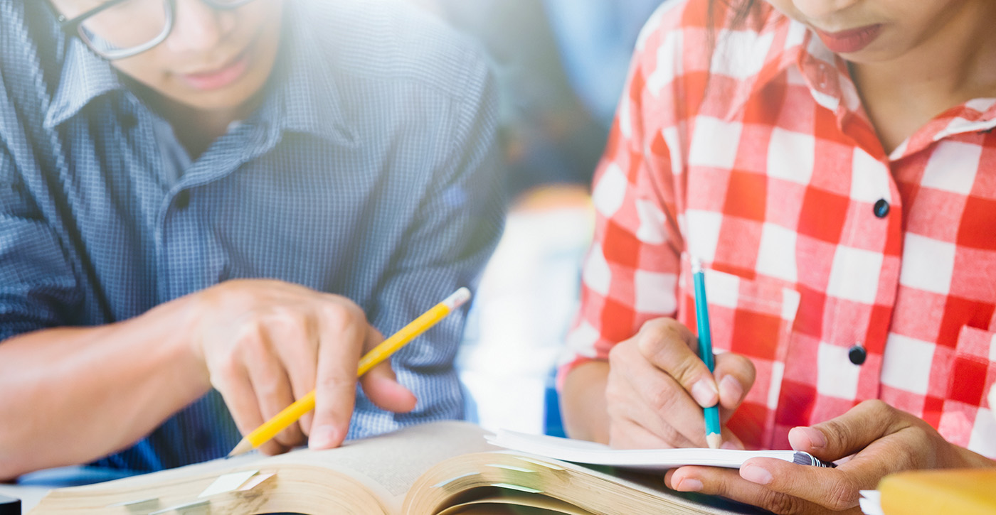 Two teachers looking at a book together