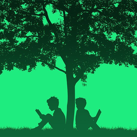 Silhouettes of children read book under tree