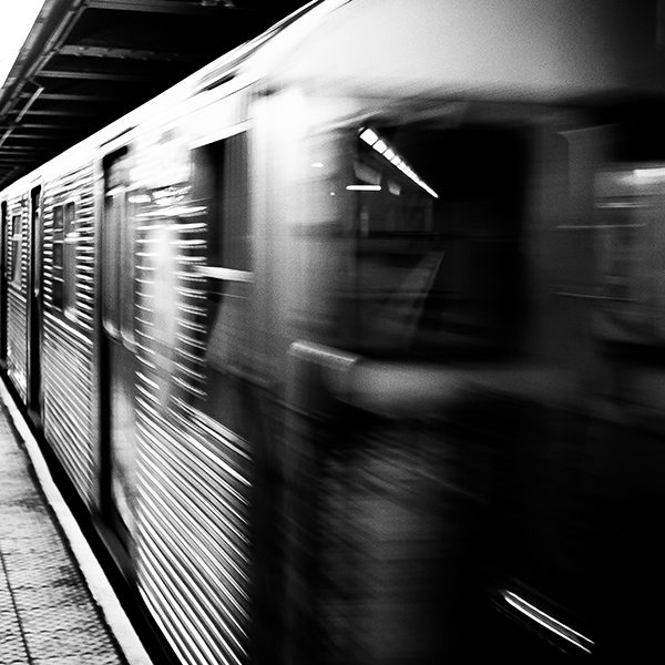 blurry train going fast through subway station