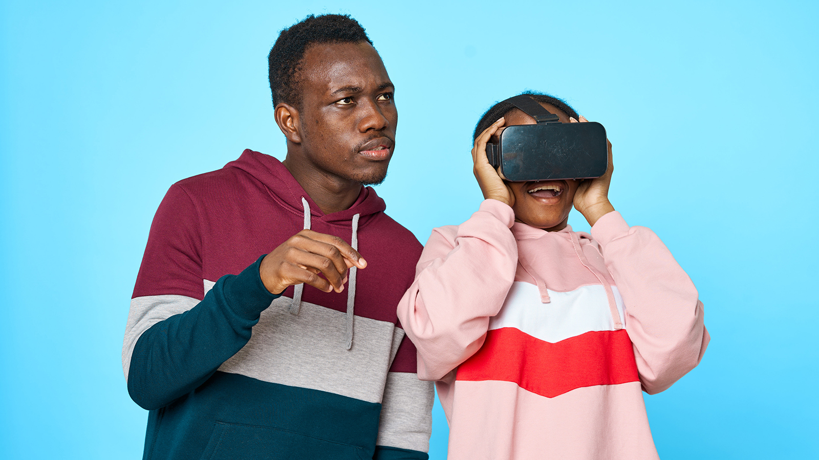 Child wearing VR headset with Father watching