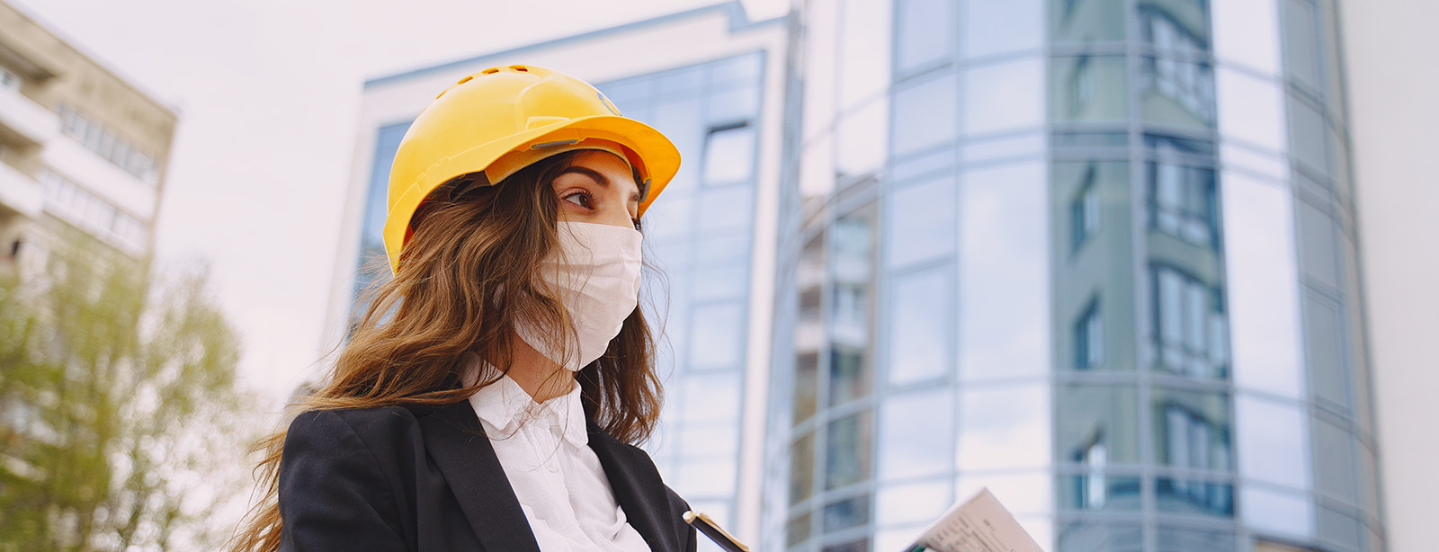 Female architect with construction site on the background