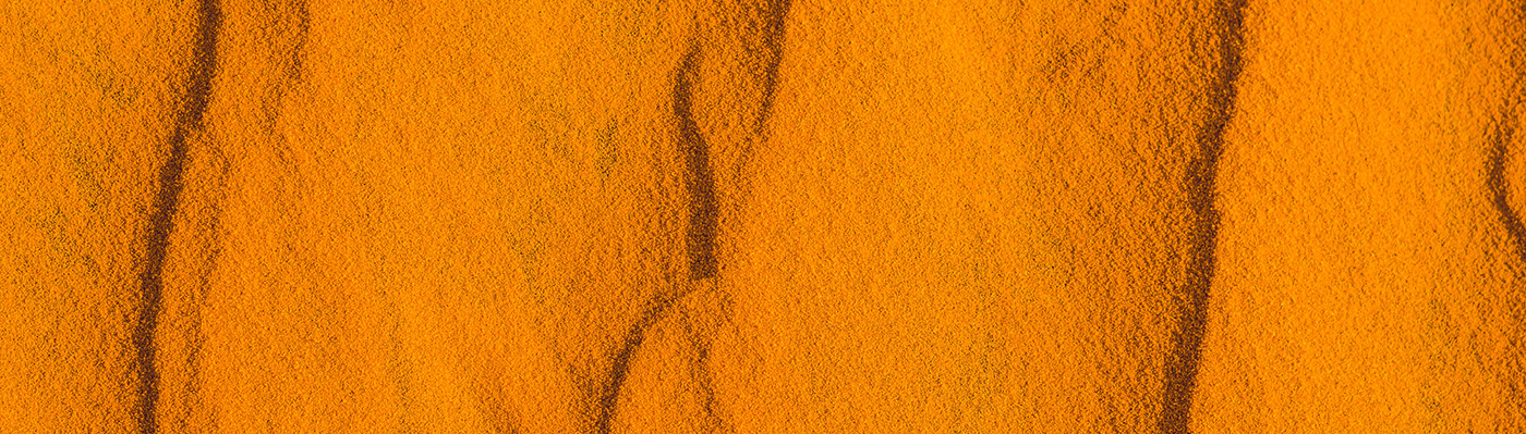 Sand with waves in the red desert.