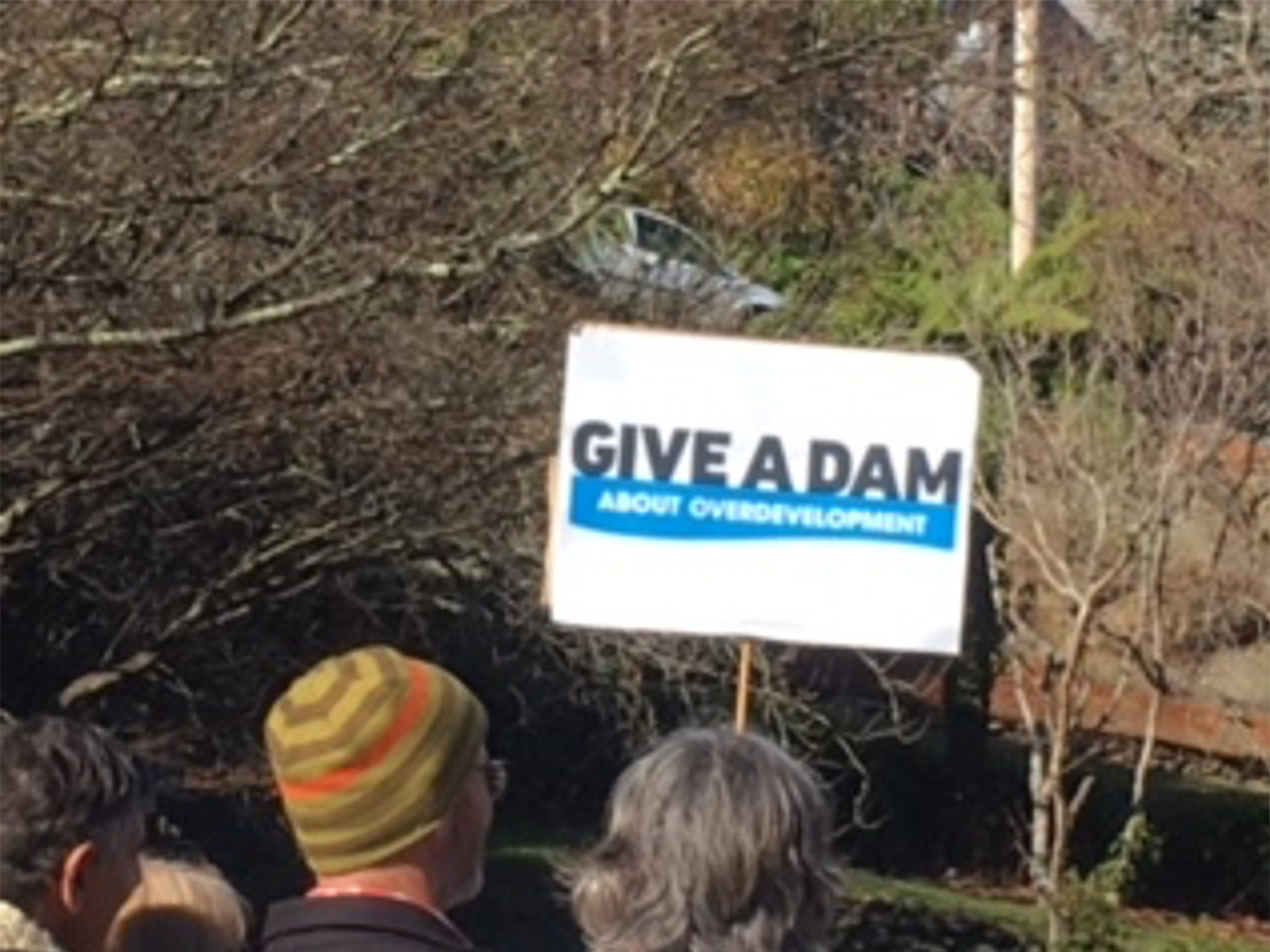 Protestor holding Give a Dam sign