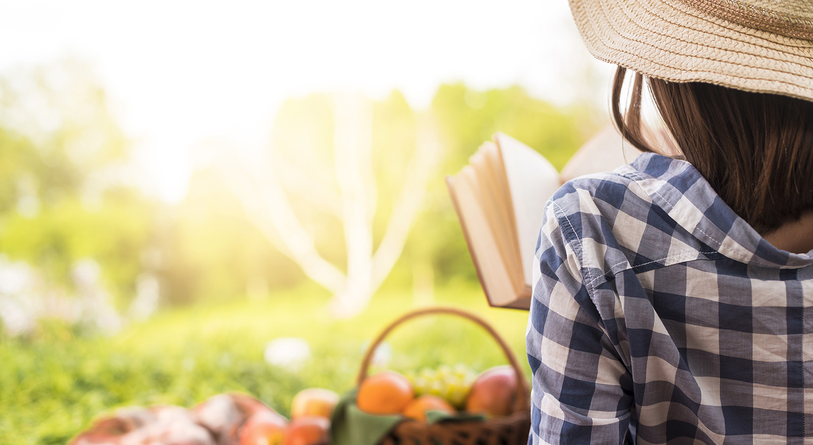 Woman relaxing and reading a book in the prk