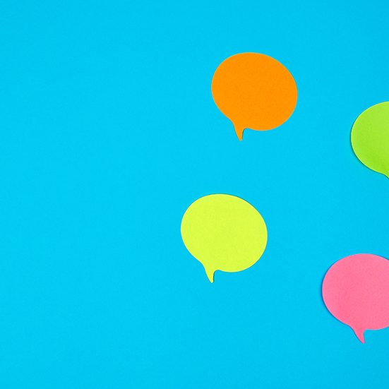 colour paper stickers on a blue background, close up colour paper stickers on a blue background, close up image