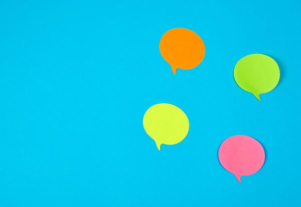 colour paper stickers on a blue background, close up colour paper stickers on a blue background, close up image