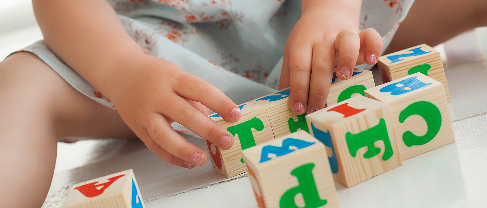 Girl playing with alphabet blocks