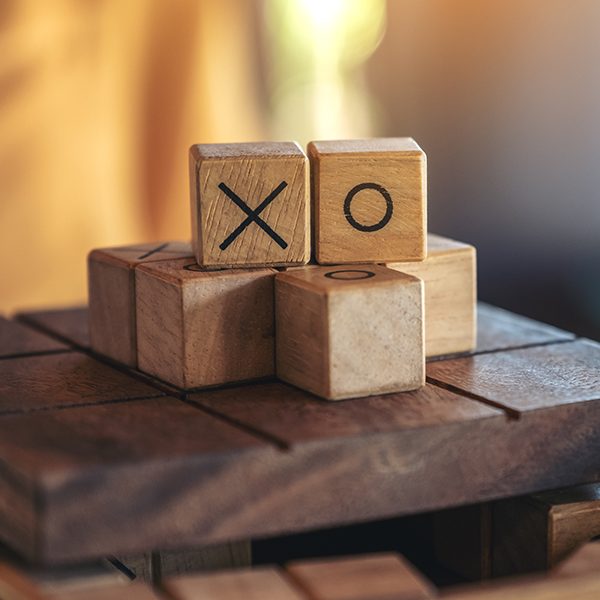 Closeup image of wooden Tic Tac Toe game or OX game in a box favourite maths games sso