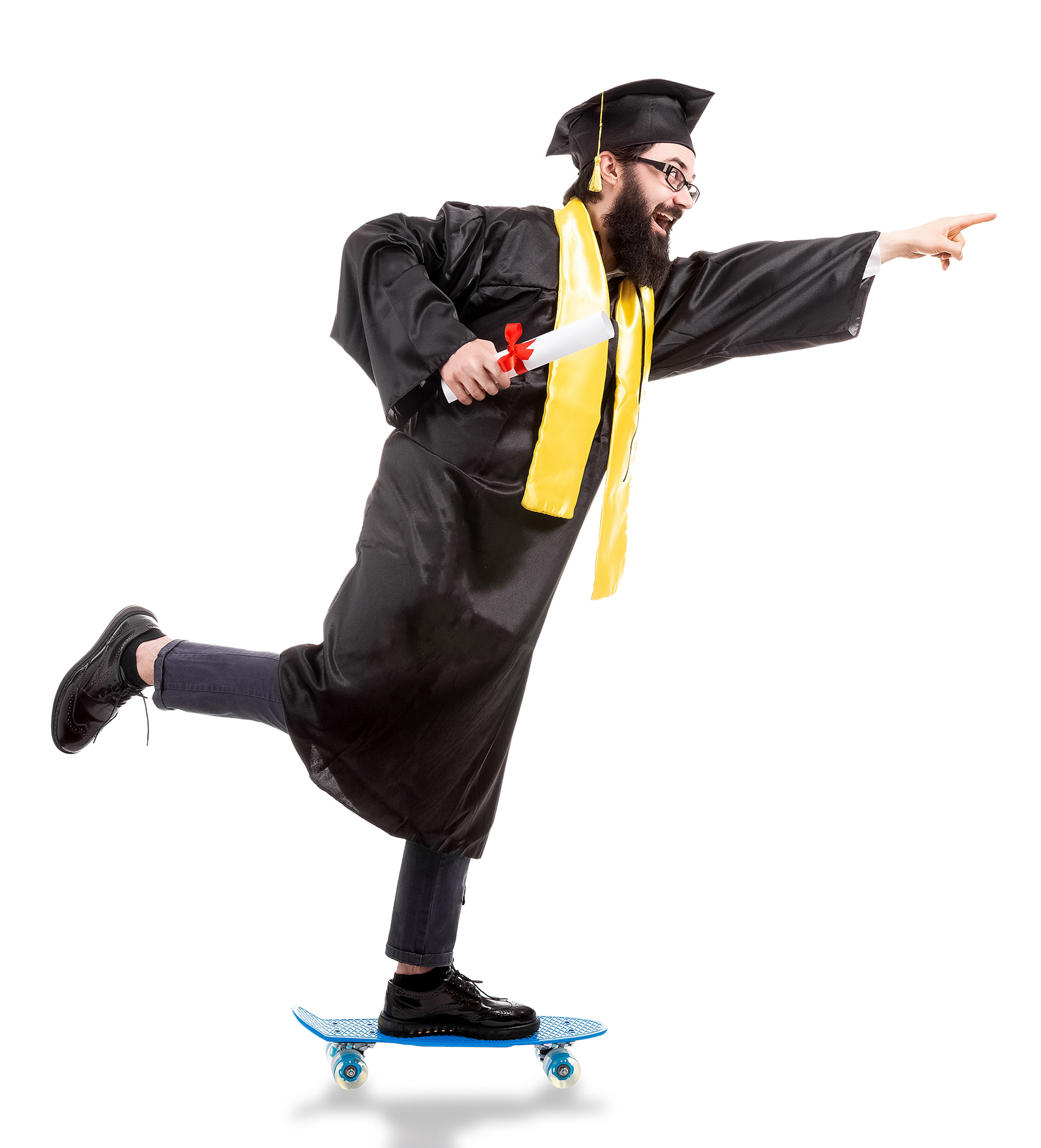 full length portrait of happy, bearded hipster graduate riding a skateboard, pointing forward and holding diploma, isolated on white background