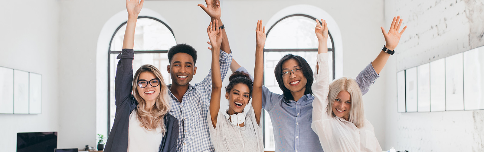 International students celebrating end of exams and laughing in lecture hall.