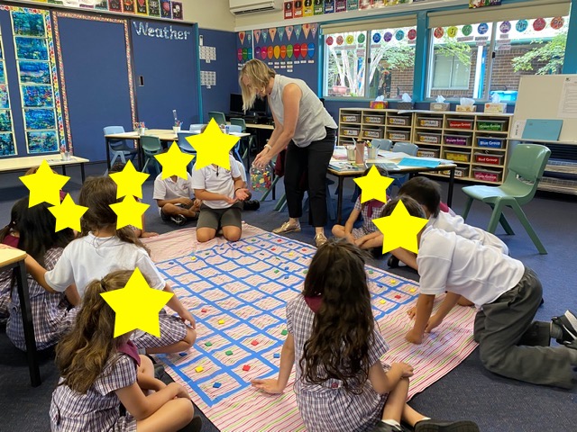 image-2-hundreds-chart students placing tiles on hundreds chart