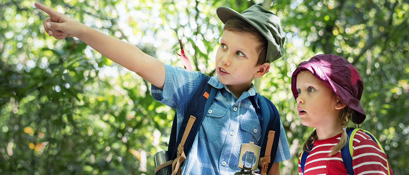 Two kids trekking in the forest
