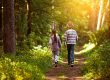 Two children walking together in the forest with warm light