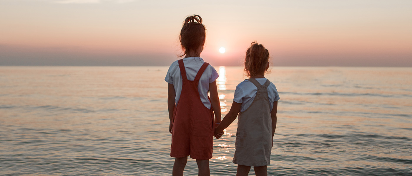 vacation at sea. A family walks along the beach. children holding hands vacation at sea. A family walks along the beach. children holding hands