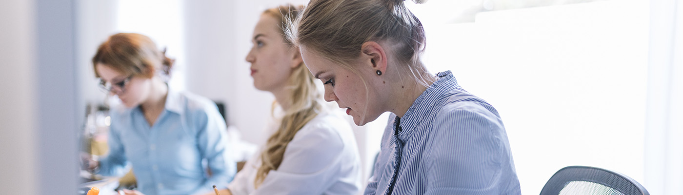 businesswomen sitting in a row in an office
