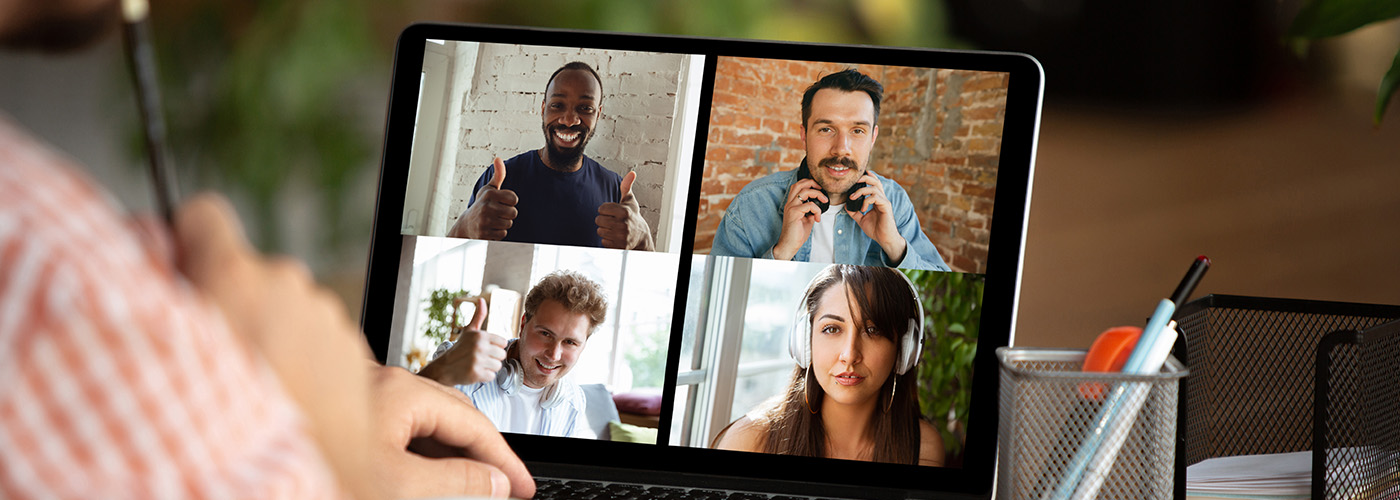 Remote meeting. Man working from home during coronavirus or COVID-19 quarantine, remote office concept. Young businessman, manager in front of monitor during online conference with colleagues and team.