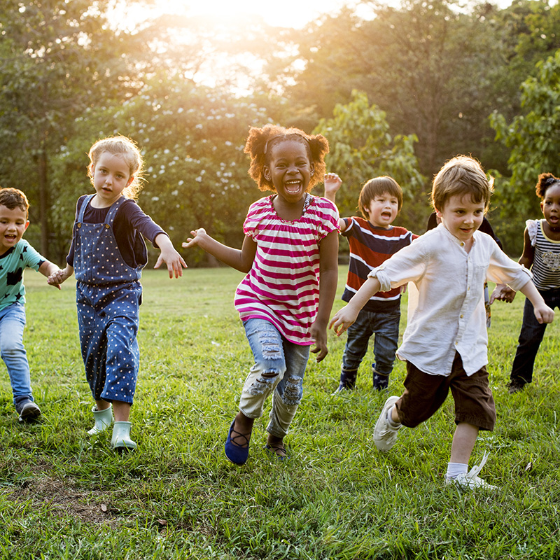 Group of Diverse Kids Playing at the Field Together Group of Diverse Kids Playing at the Field Together
